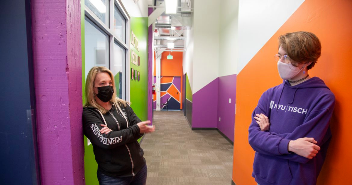 Student and teacher standing in hallway