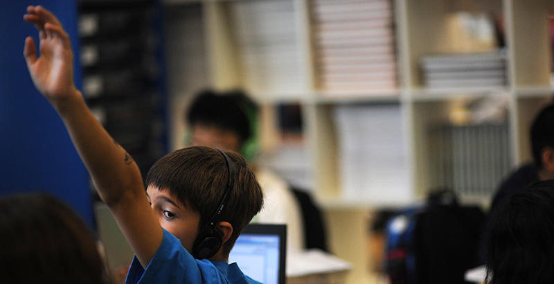 Student raising hand in class