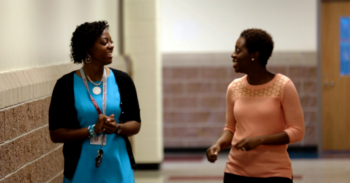 Administrators talking in a hallway