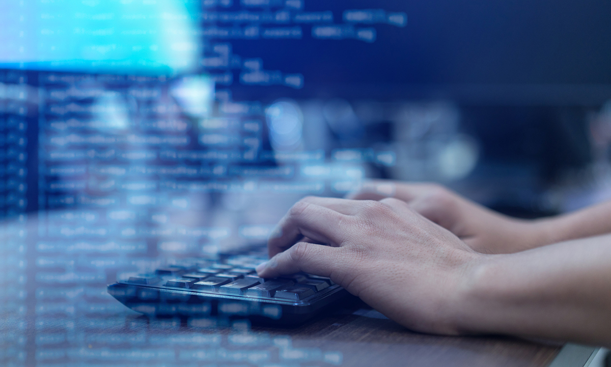 close up programmer man hand typing on keyboard at computer desktop for input coding language to software for fix bug and defect of system in operation room , technology concept